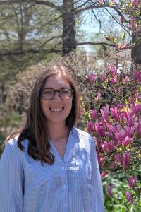 Woman in front of flowers