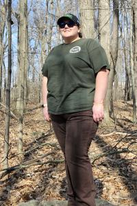 Antoinette Shirley smiles, surrounded by a forest