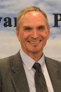 Portrait of a man in a suit jacket and tie