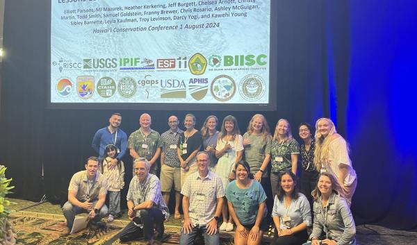 Forum co-organizers, speakers, and facilitators standing, sitting, or kneeling together for a photo at the Hawaiʻi Conservation Conference 